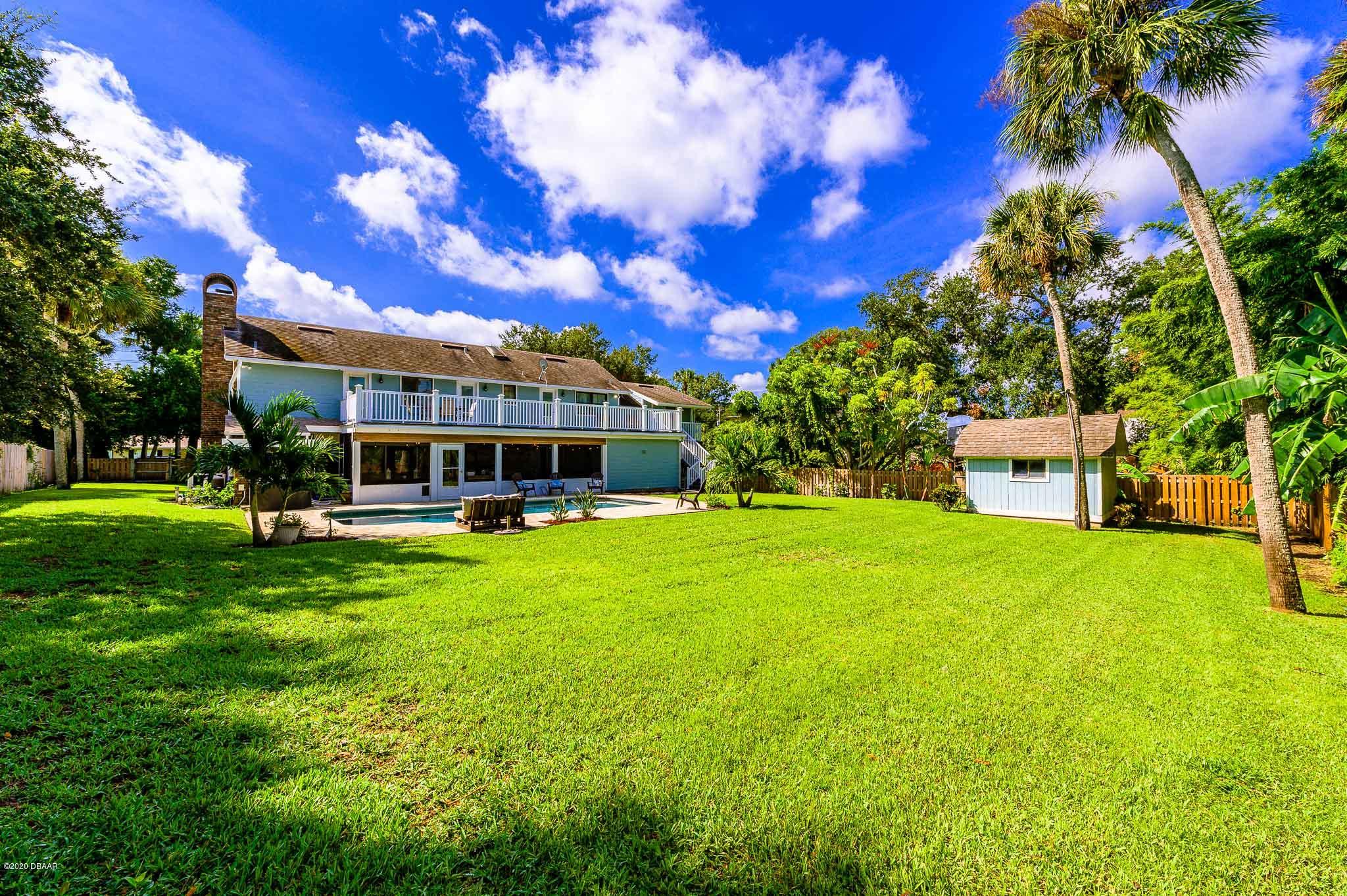 35 Neptune Avenue Ormond Beach, FL 32176 - Photo 13 of 58 a front view of a house with a garden