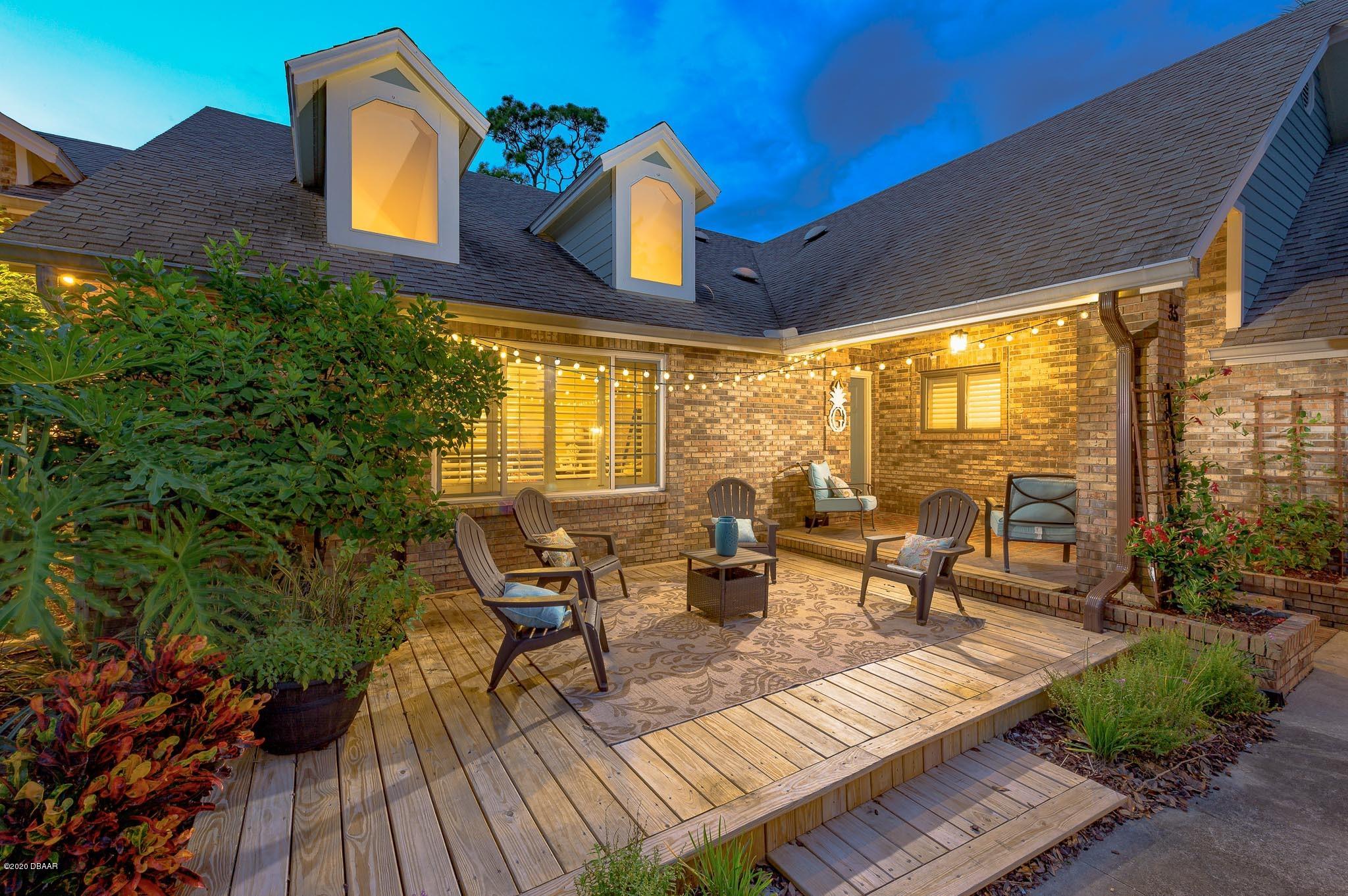 35 Neptune Avenue Ormond Beach, FL 32176 - Photo 2 of 58 a view of a patio with couches table and chairs and potted plants