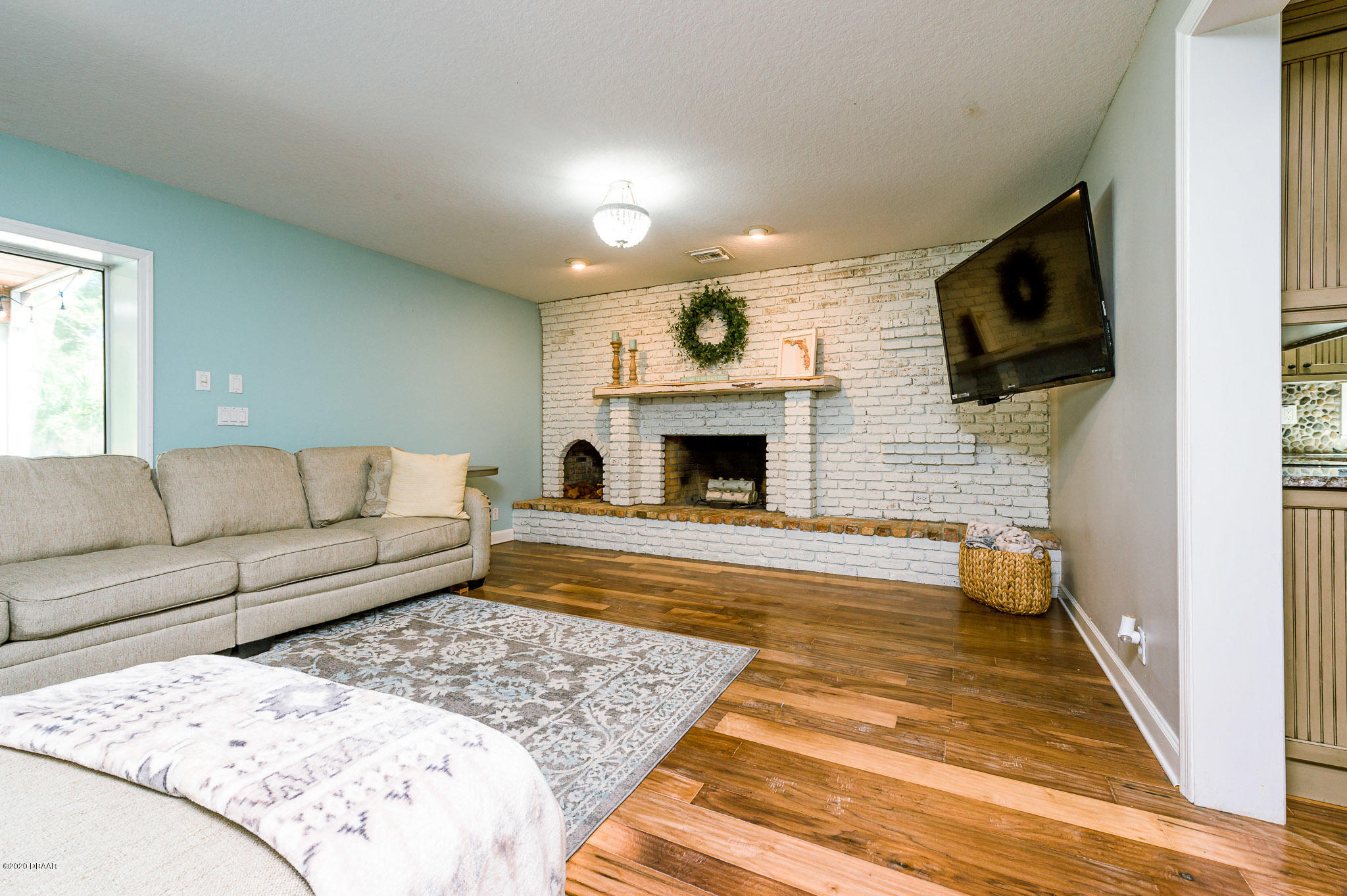 35 Neptune Avenue Ormond Beach, FL 32176 - Photo 22 of 58 a living room with furniture and a fireplace