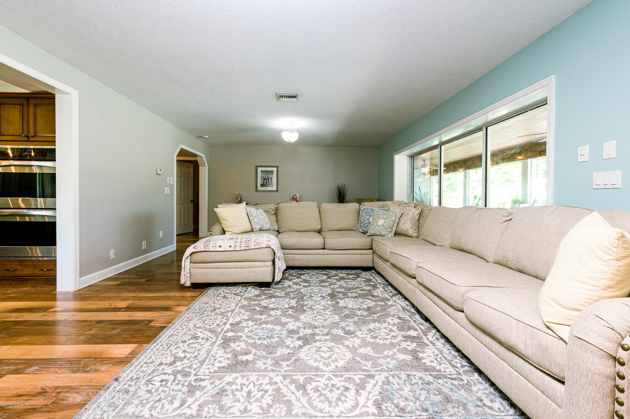 35 Neptune Avenue Ormond Beach, FL 32176 - Photo 24 of 58 a living room with furniture and a rug