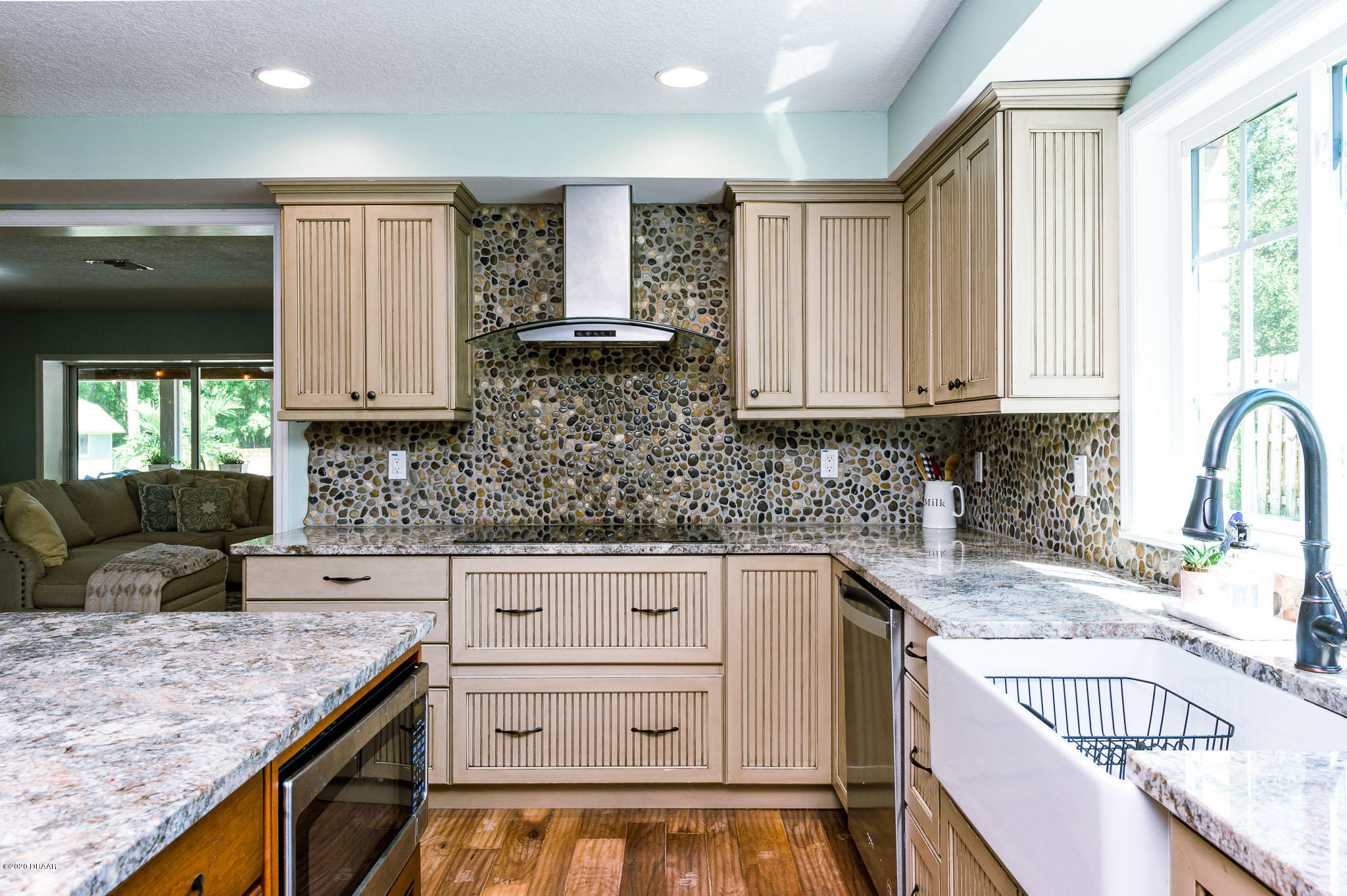 35 Neptune Avenue Ormond Beach, FL 32176 - Photo 28 of 58 a kitchen with granite countertop a sink stove and cabinets