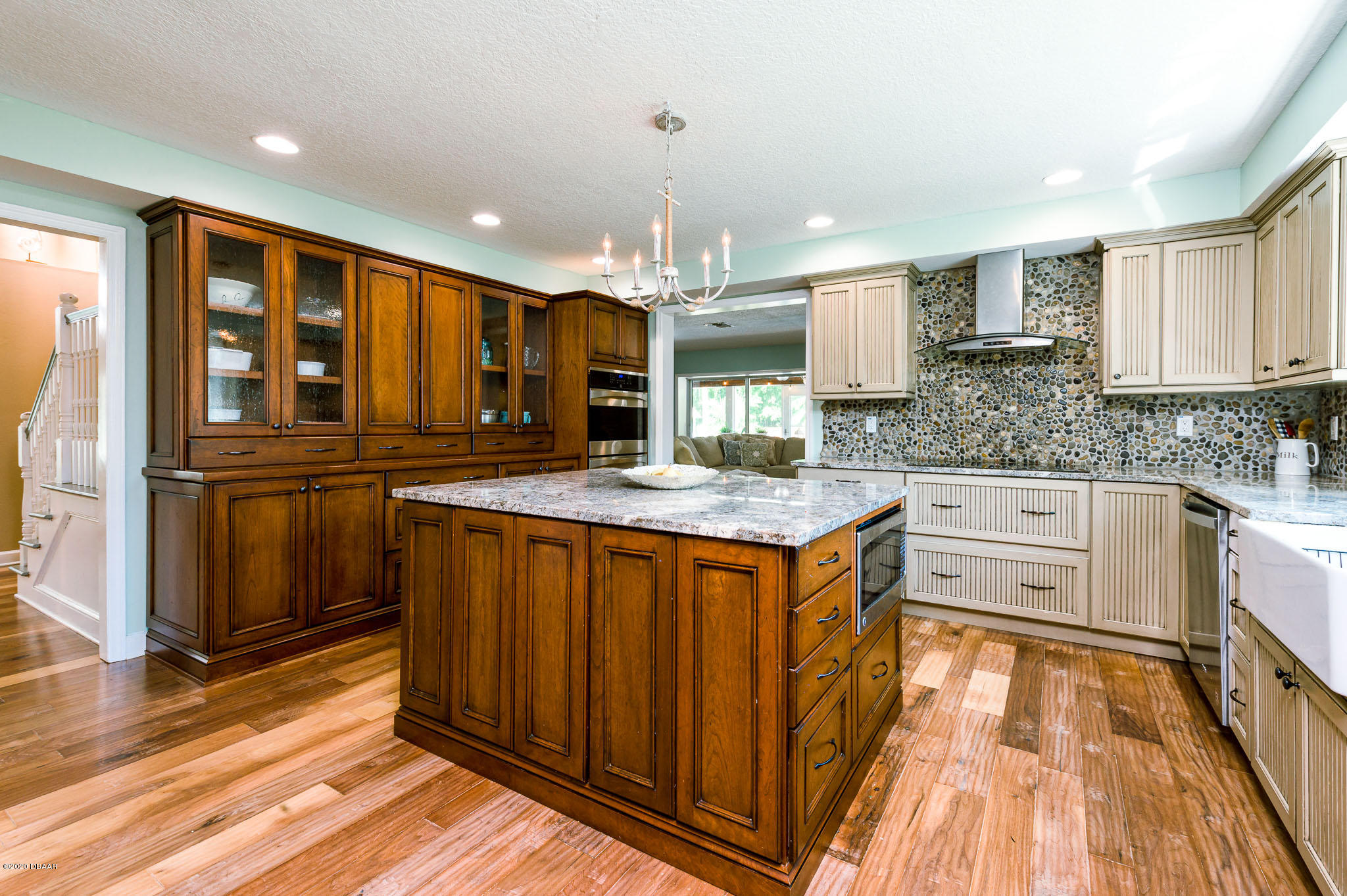 35 Neptune Avenue Ormond Beach, FL 32176 - Photo 29 of 58 a kitchen with stainless steel appliances granite countertop a refrigerator a sink dishwasher and wooden cabinets with wooden floor