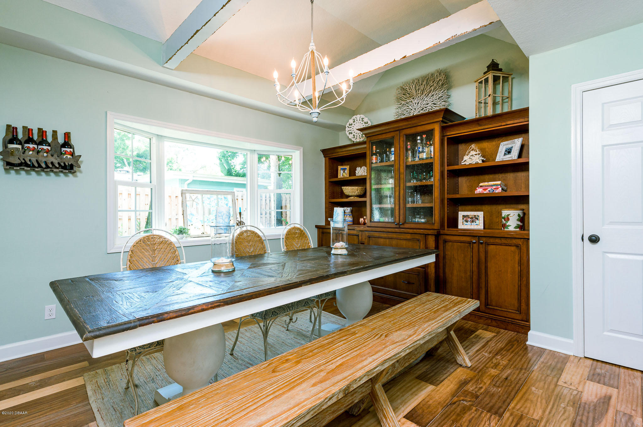 35 Neptune Avenue Ormond Beach, FL 32176 - Photo 30 of 58 a dining room with stainless steel appliances granite countertop a table chairs and a wooden floor