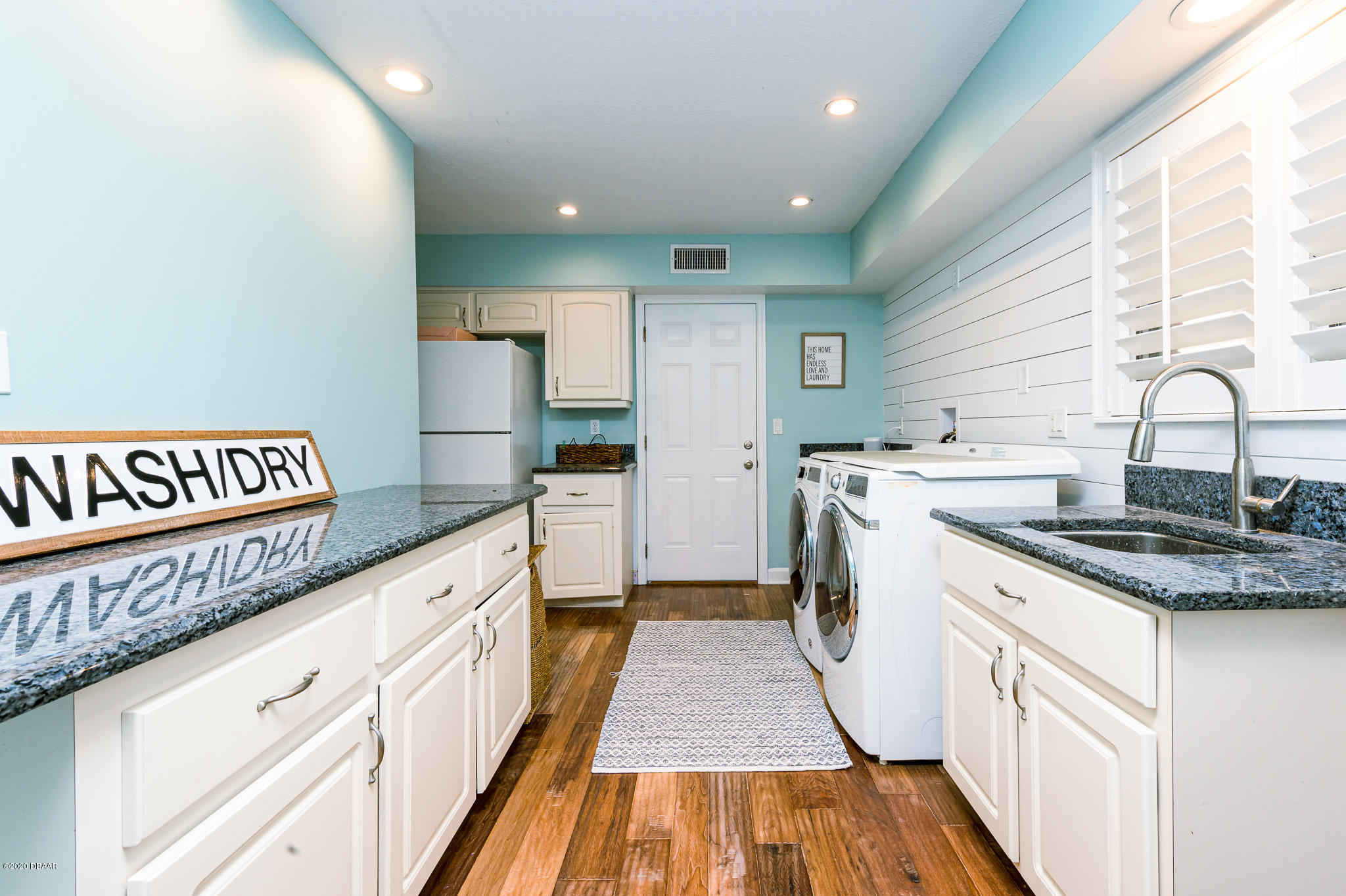 35 Neptune Avenue Ormond Beach, FL 32176 - Photo 32 of 58 a kitchen with granite countertop a sink and a stove top oven