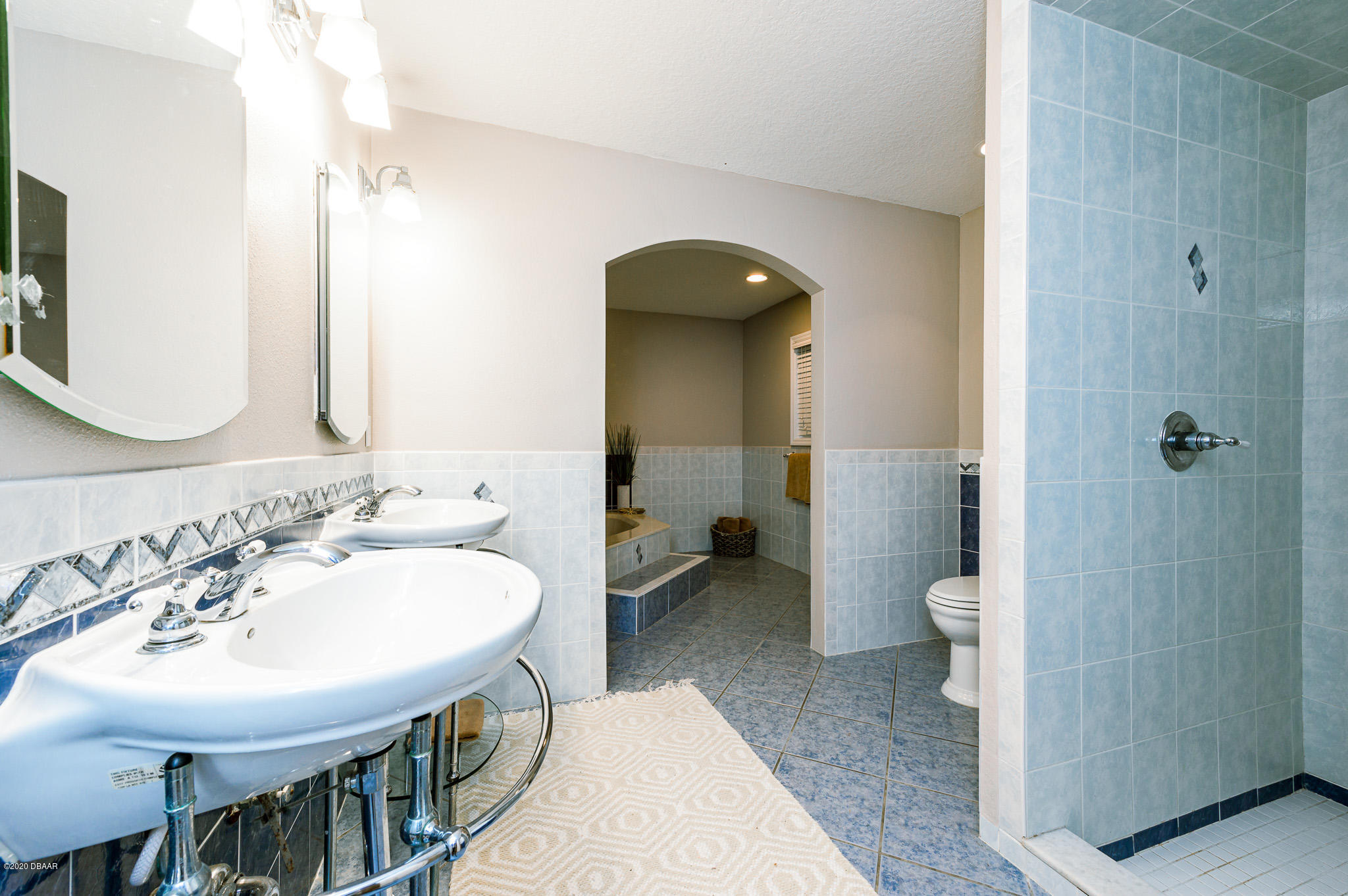 35 Neptune Avenue Ormond Beach, FL 32176 - Photo 35 of 58 a spacious bathroom with a sink and a mirror
