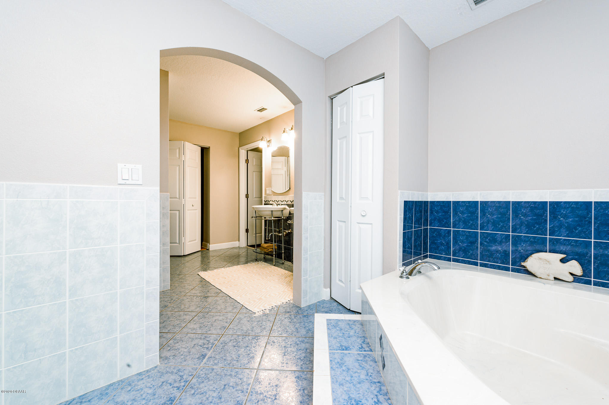 35 Neptune Avenue Ormond Beach, FL 32176 - Photo 36 of 58 a spacious bathroom with a tub and mirror