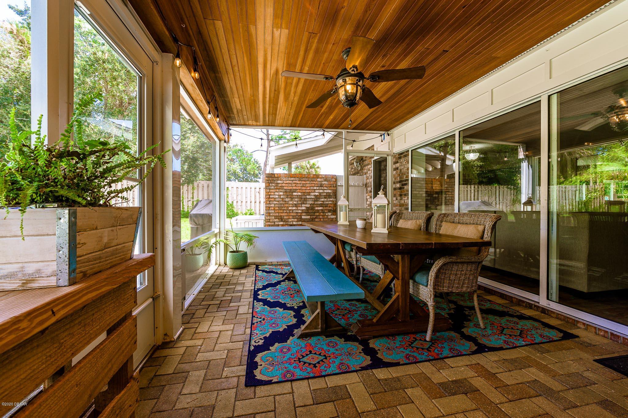 35 Neptune Avenue Ormond Beach, FL 32176 - Photo 38 of 58 a outdoor space with lots of furniture and glass windows