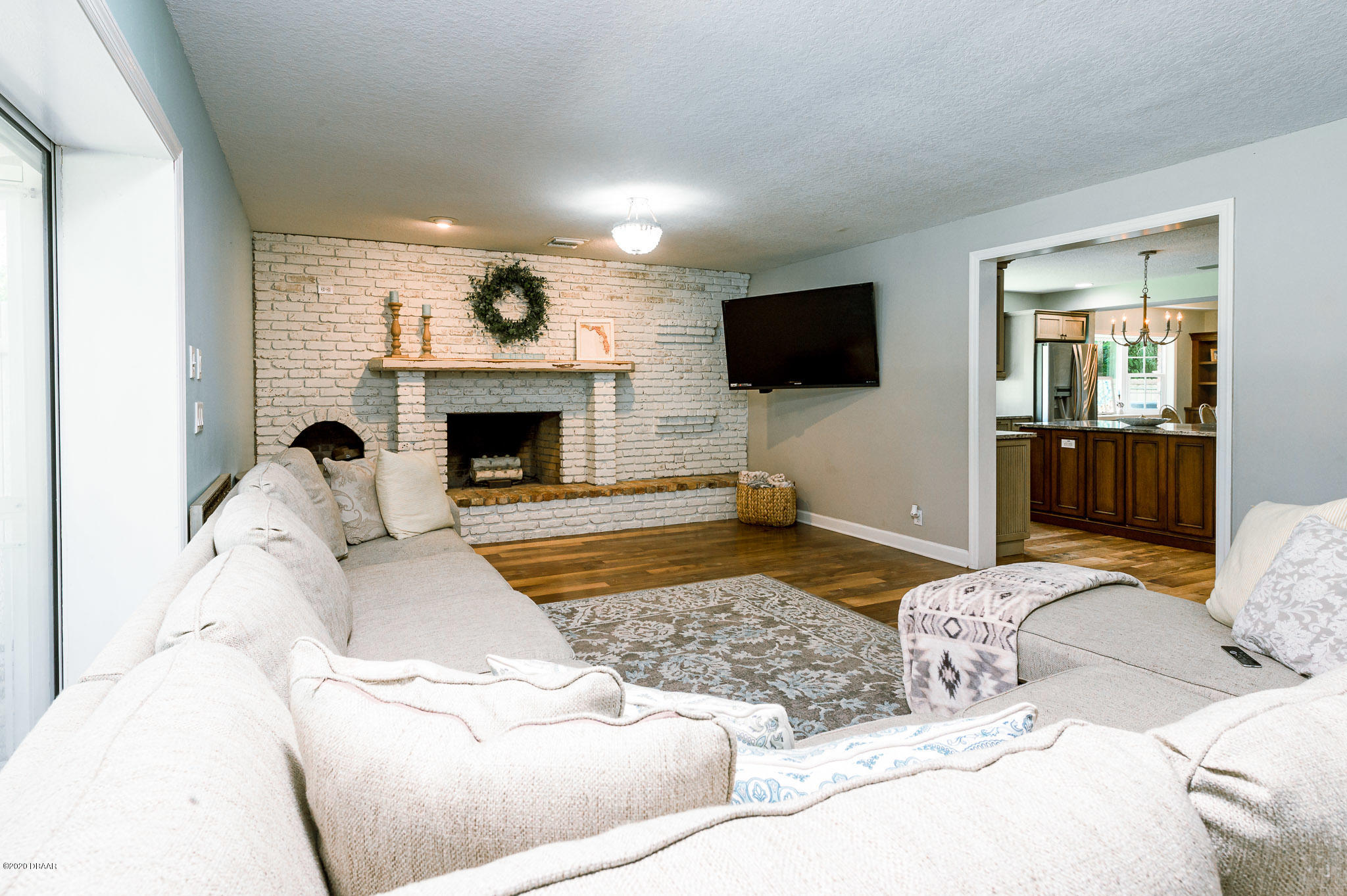 35 Neptune Avenue Ormond Beach, FL 32176 - Photo 39 of 58 a living room with furniture and a fireplace