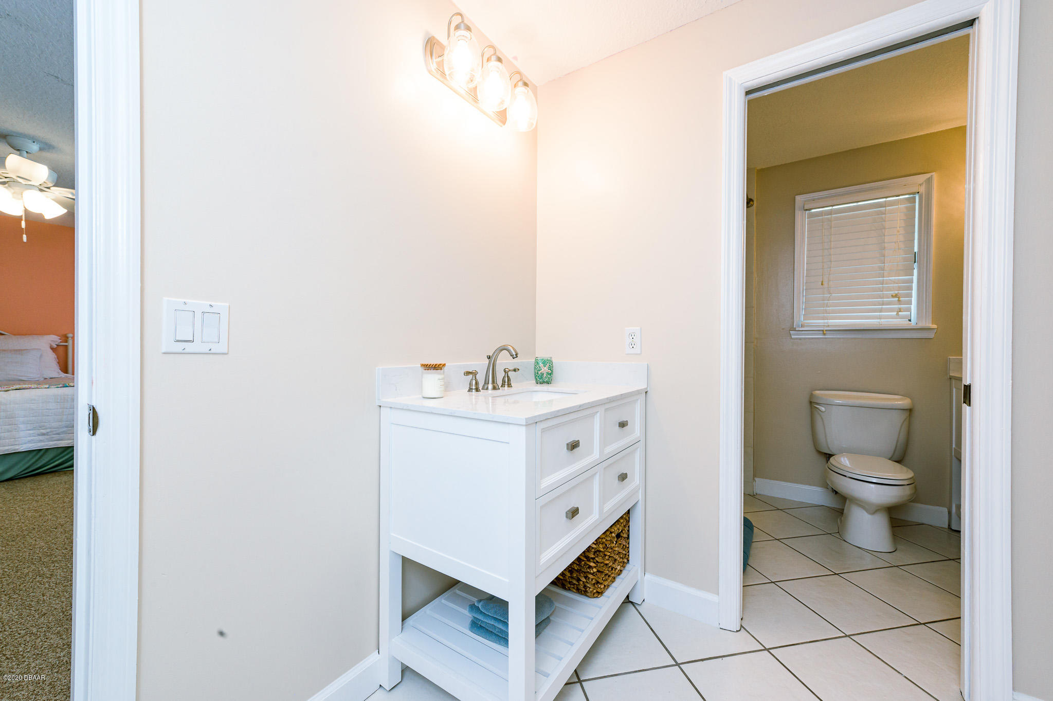 35 Neptune Avenue Ormond Beach, FL 32176 - Photo 46 of 58 a bathroom with a sink mirror and a toilet