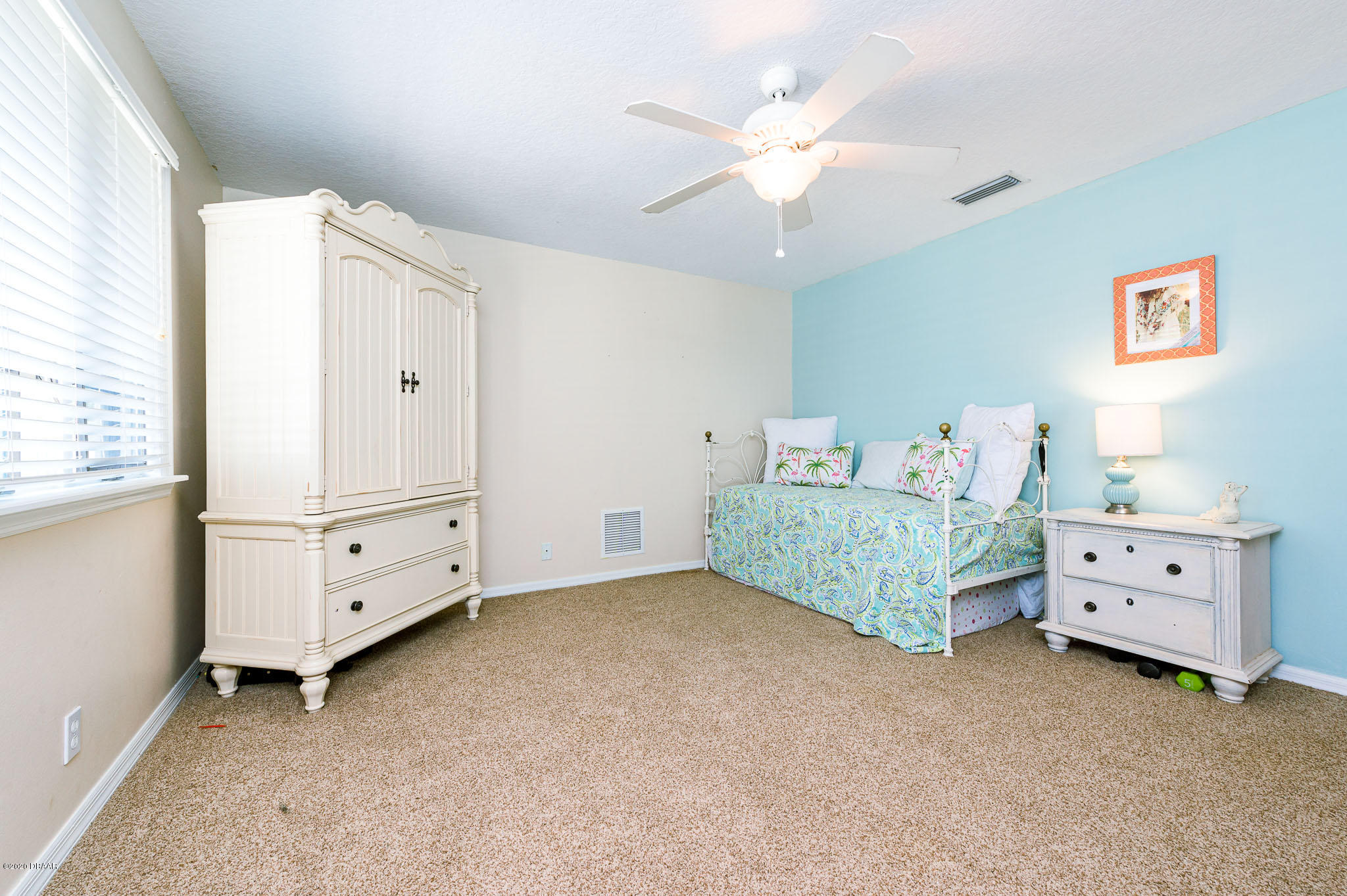 35 Neptune Avenue Ormond Beach, FL 32176 - Photo 48 of 58 a bedroom with a baby bed dresser and a window