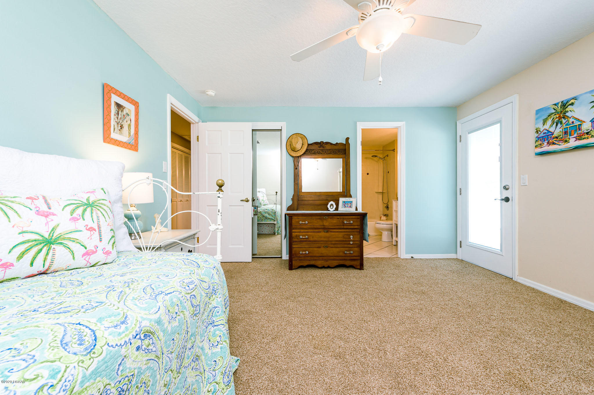 35 Neptune Avenue Ormond Beach, FL 32176 - Photo 49 of 58 a spacious bedroom with a bed and a chandelier