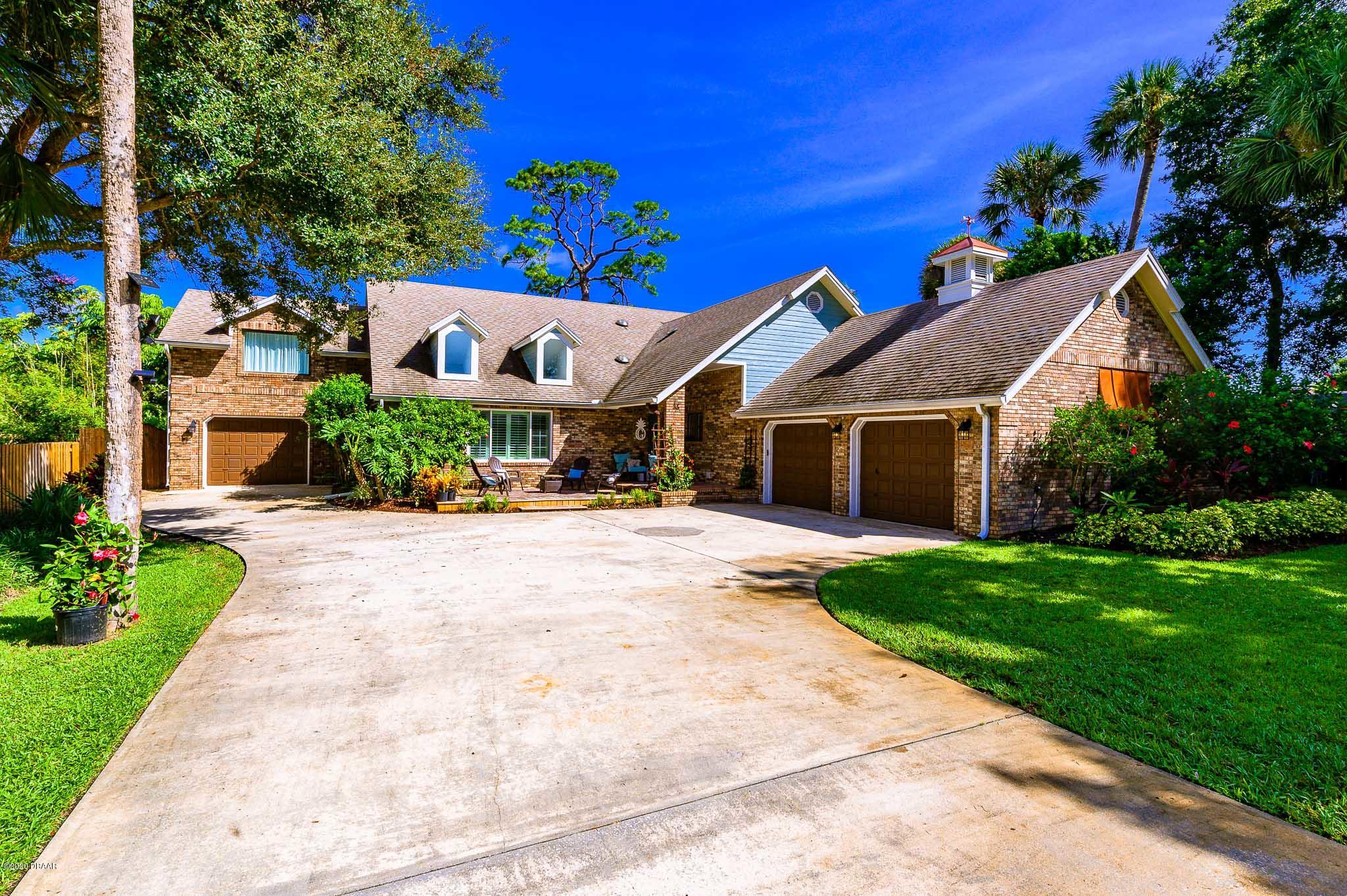 35 Neptune Avenue Ormond Beach, FL 32176 - Photo 5 of 58 a front view of a house with a yard and potted plants