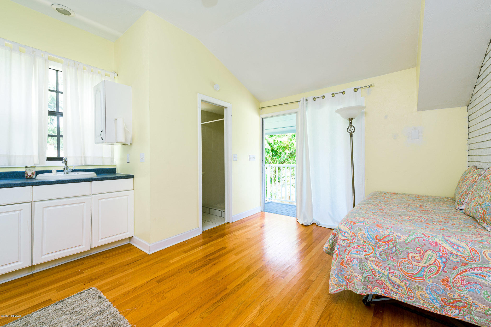 35 Neptune Avenue Ormond Beach, FL 32176 - Photo 52 of 58 a bedroom with a bed dresser and a window