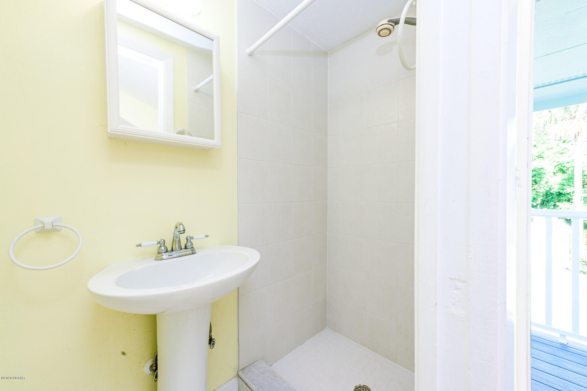 35 Neptune Avenue Ormond Beach, FL 32176 - Photo 53 of 58 a bathroom with a sink and a mirror