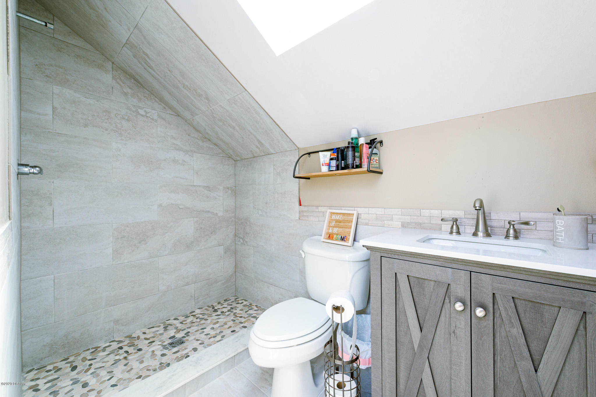35 Neptune Avenue Ormond Beach, FL 32176 - Photo 55 of 58 a bathroom with a toilet sink a shower and a window