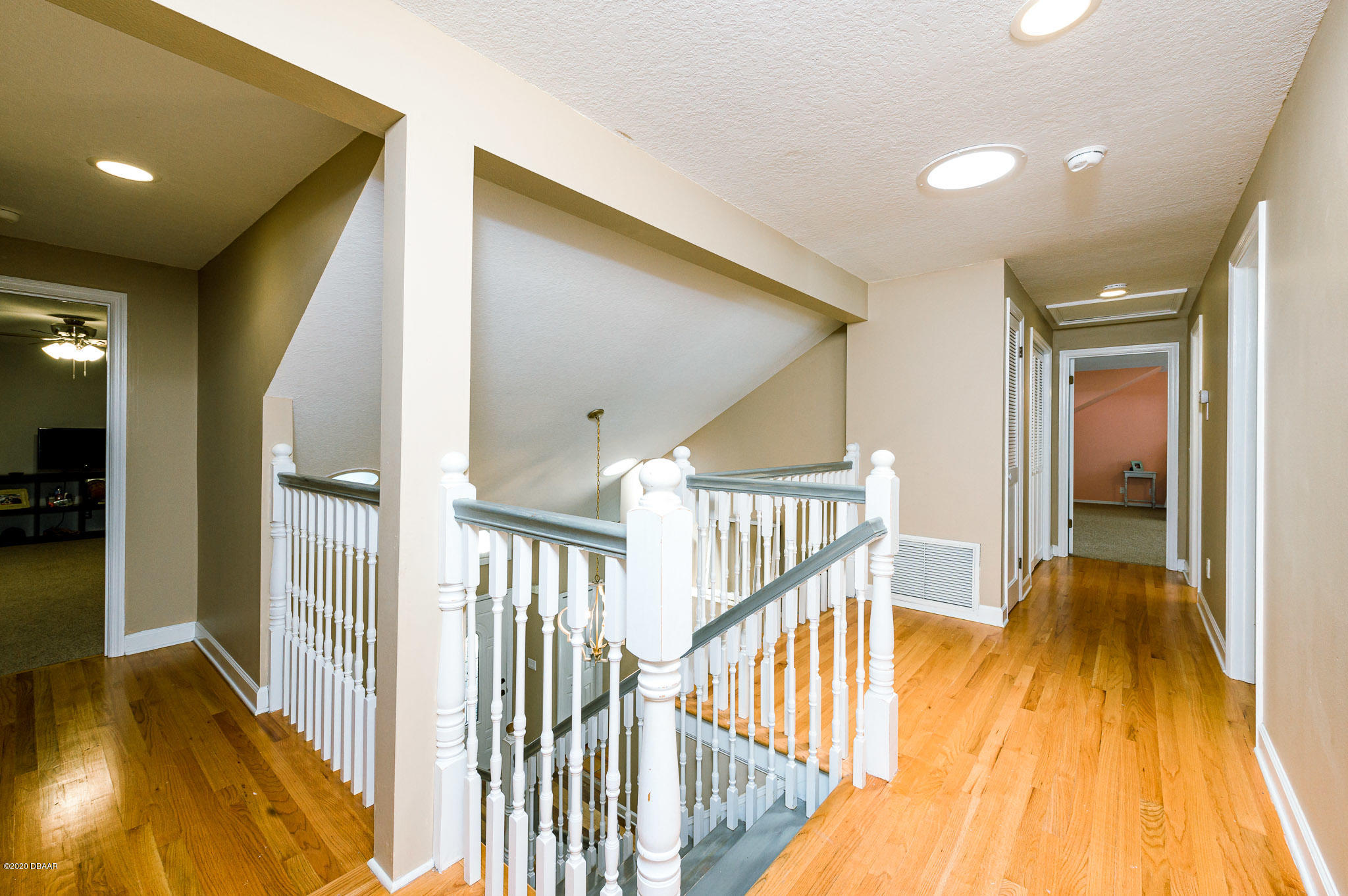 35 Neptune Avenue Ormond Beach, FL 32176 - Photo 56 of 58 a view of a hallway with wooden floor and dining room