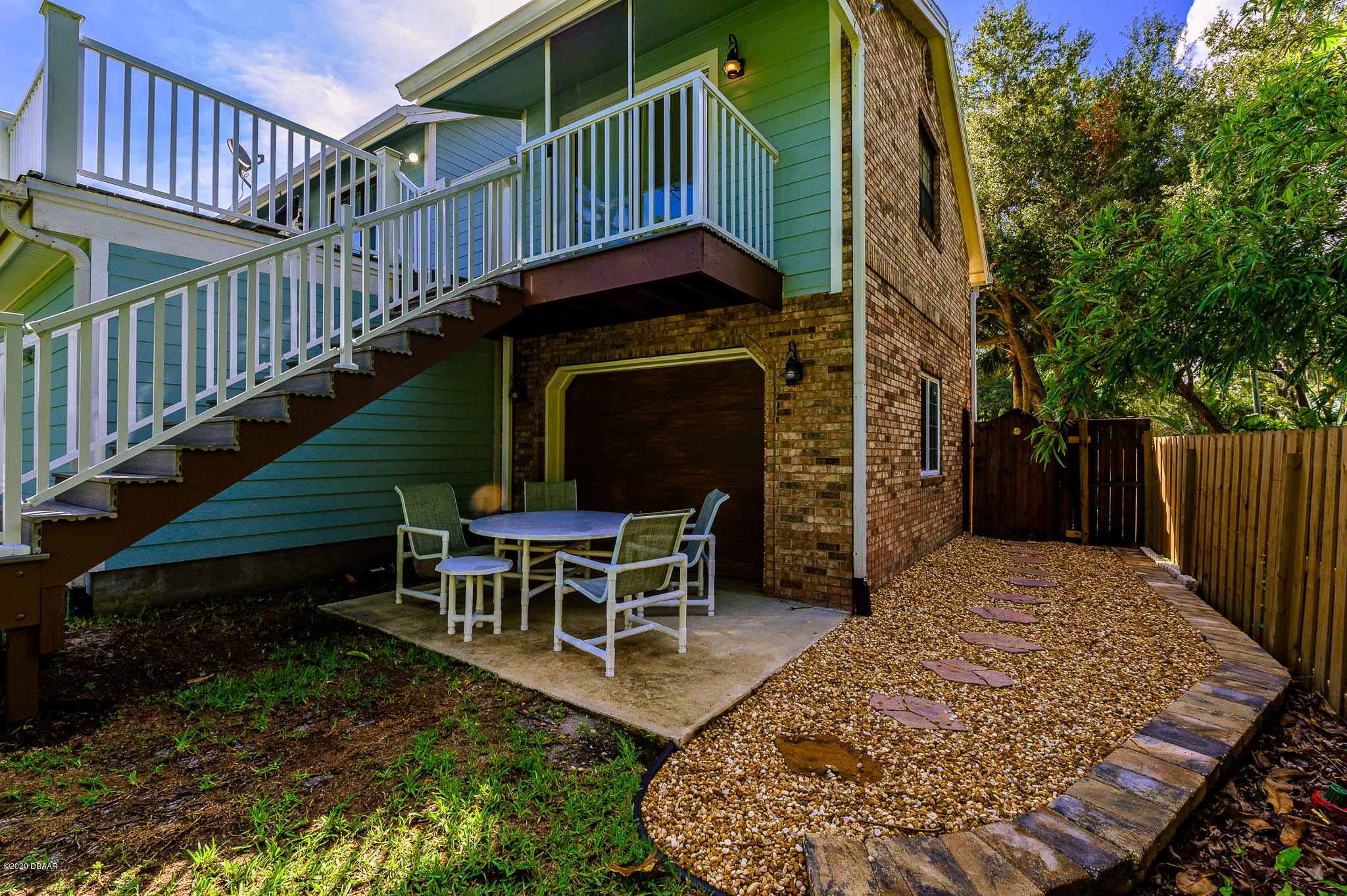 35 Neptune Avenue Ormond Beach, FL 32176 - Photo 8 of 58 a view of a chairs setting on the deck in front of house