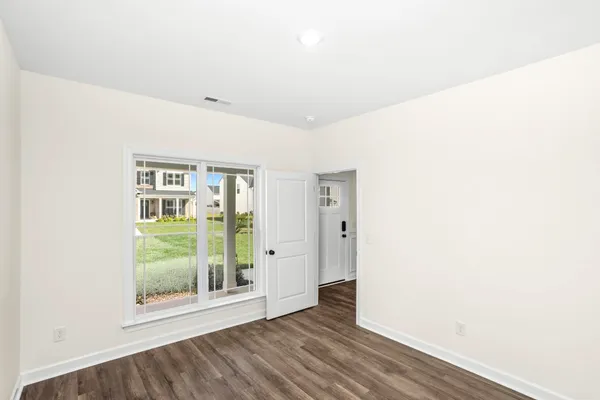 a view of an entryway with wooden floor
