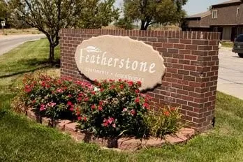 a sign that is sitting in front of flowers