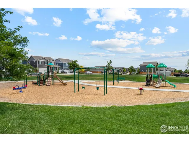 a view of outdoor space with playground and green space