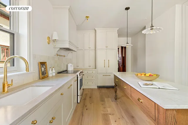 a kitchen with a stove and white cabinets