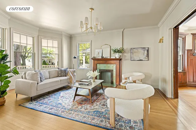 a living room with furniture a fireplace and a table