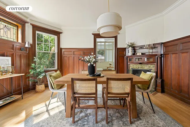 a living room with furniture a fireplace and a chandelier