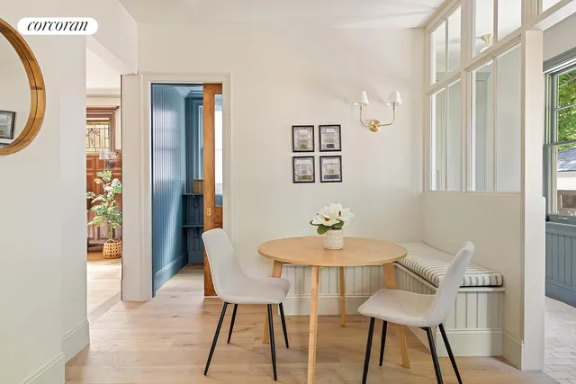 a dining room with furniture a chandelier and wooden floor
