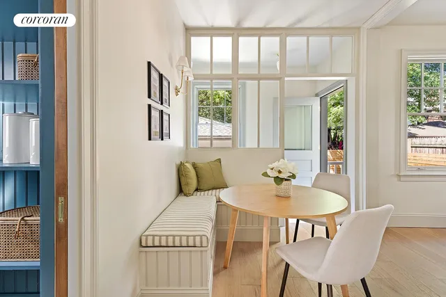 a view of a dining room with furniture and a chandelier