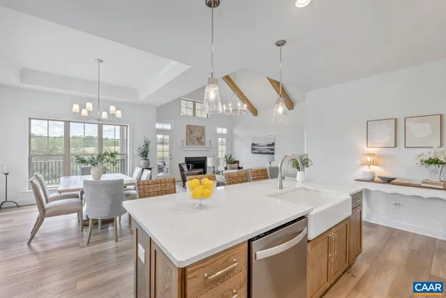 a view of a kitchen area with furniture and wooden floor