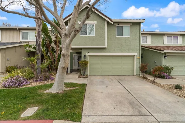 a front view of a house with a yard and garage