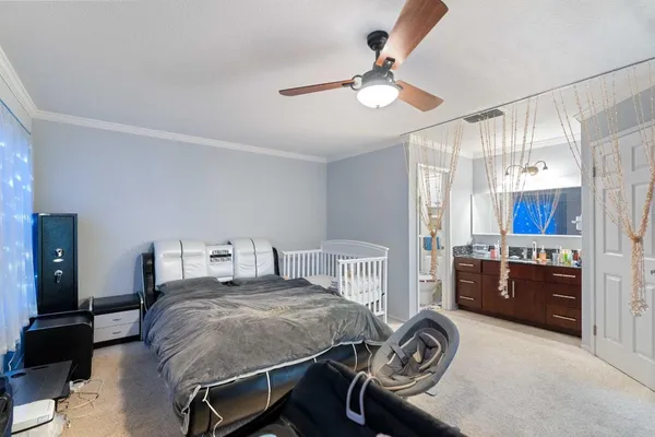 a bedroom with a bed and ceiling fan