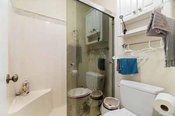 a bathroom with a toilet and a shower