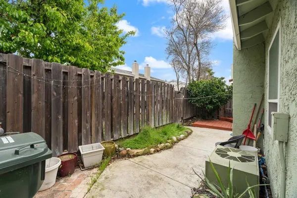 a view of a backyard with wooden fence