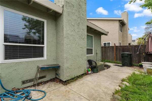 a backyard of a house with table and chairs