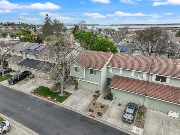 an aerial view of a house with a yard and large tree
