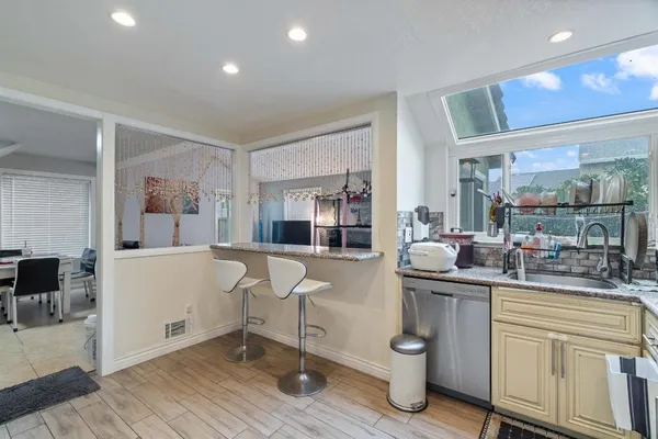 a kitchen with a sink cabinets and wooden floor