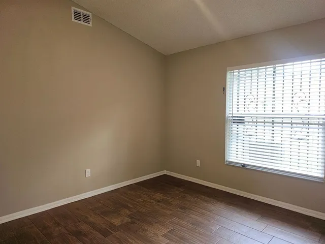 wooden floor and window in an empty room
