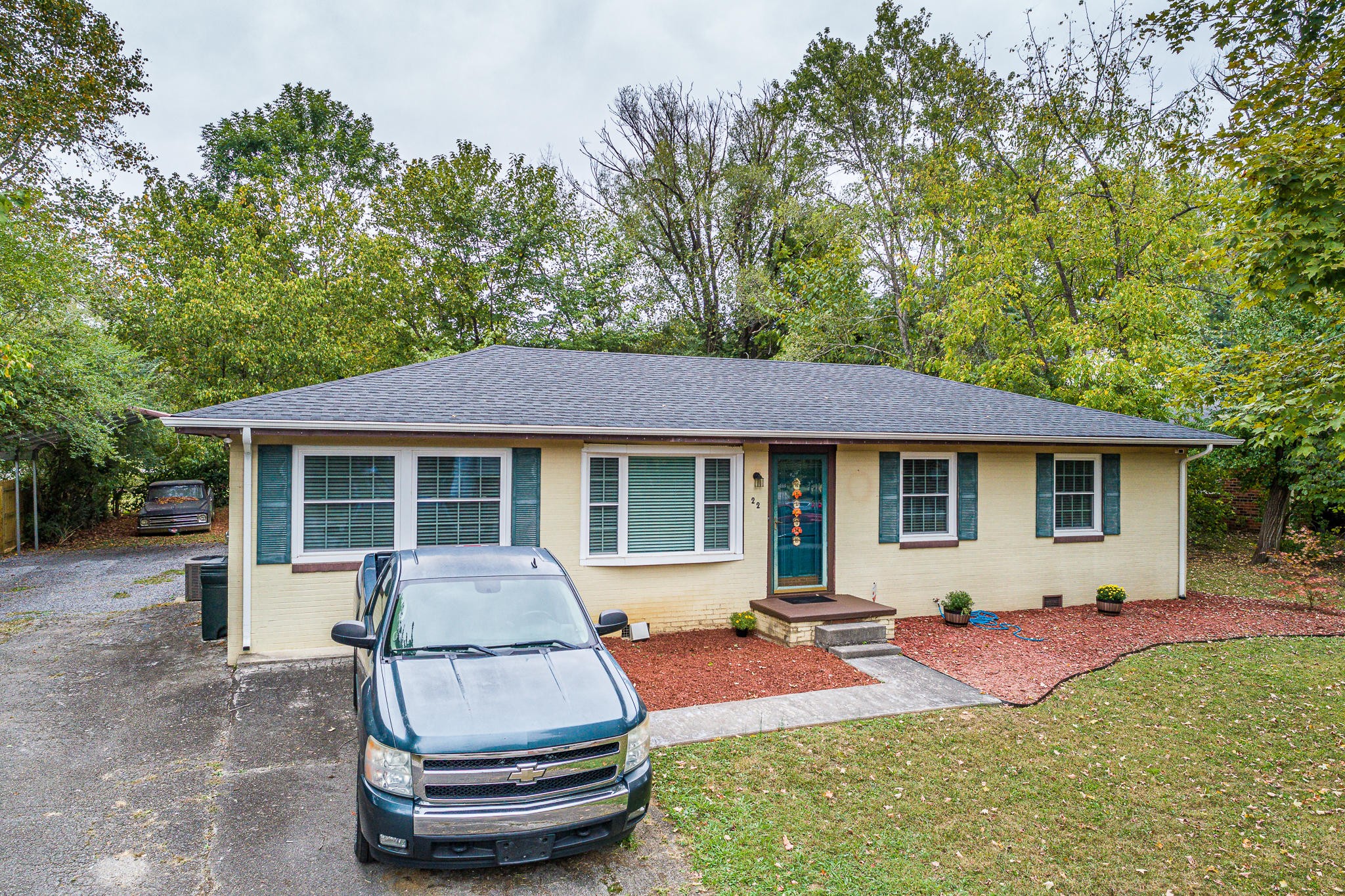 22 Lindale Lane Oak Ridge, TN 37830 - Photo 1 of 26 a front view of a house with a yard porch and wooden fence