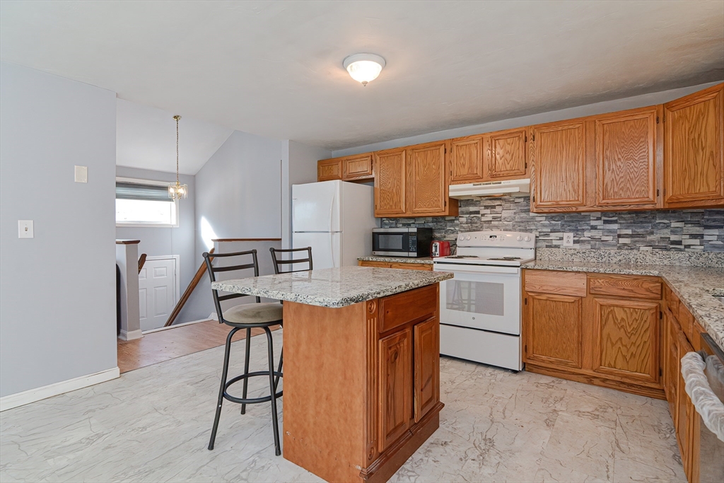 38 Clark Road Sturbridge, MA 01518 - Photo 6 of 30 a kitchen with granite countertop a sink appliances cabinets and counter space