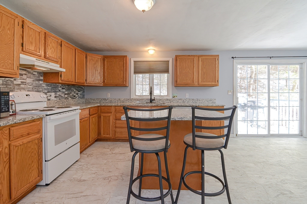 38 Clark Road Sturbridge, MA 01518 - Photo 9 of 30 a kitchen with granite countertop a sink cabinets and window