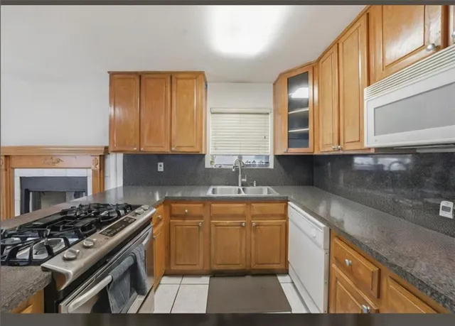 a kitchen that has a sink and a stove