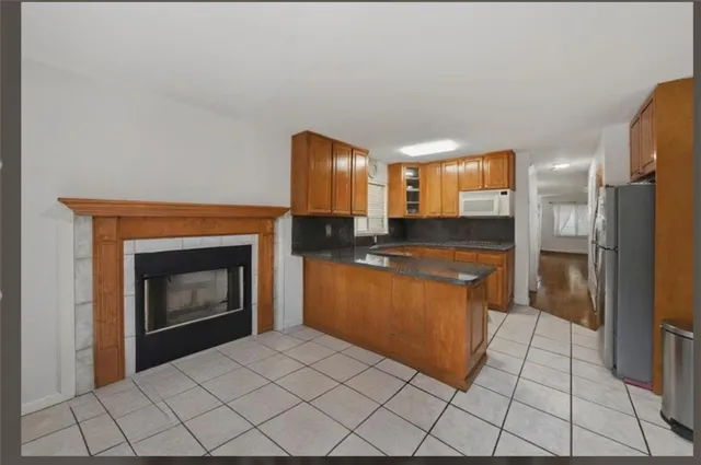 a large kitchen with cabinets and a fireplace