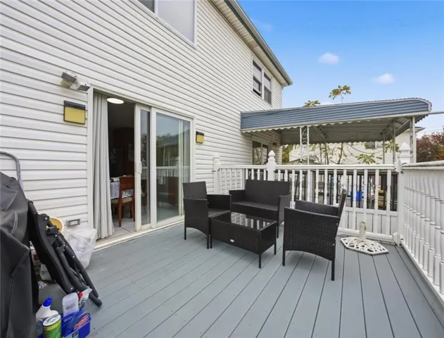 a view of a deck with wooden floor and outdoor seating