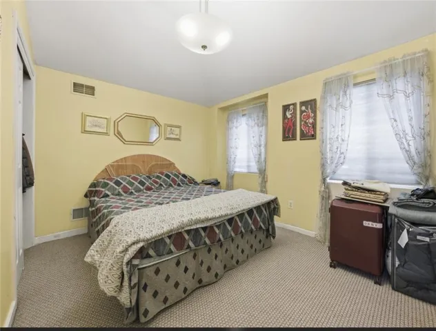 a bedroom with a bed and dresser
