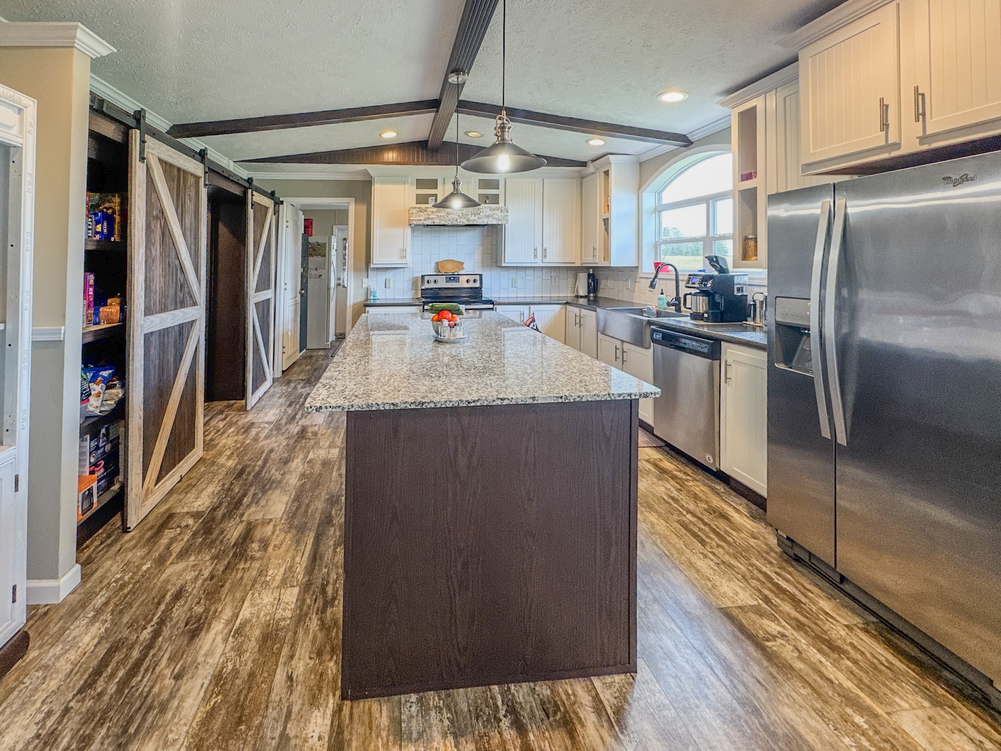 1198 David Patterson Road Lutts, TN 38471 - Photo 15 of 82 a kitchen with stainless steel appliances granite countertop a refrigerator a stove and a wooden floors