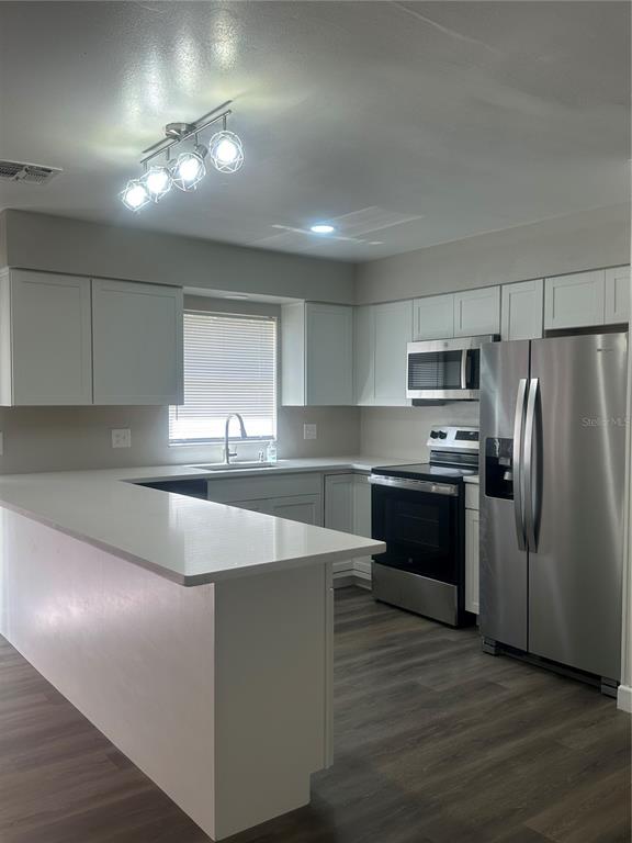 5400 Fox Briar Trail Orlando, FL 32808 - Photo 4 of 31 a kitchen with granite countertop a refrigerator and a stove top oven