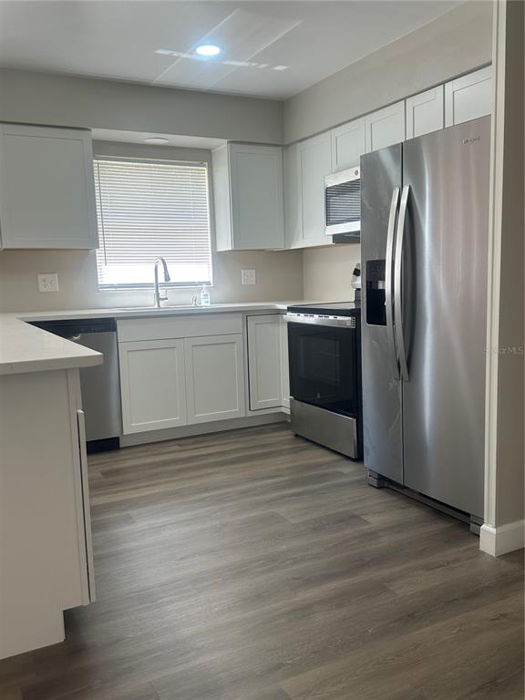5400 Fox Briar Trail Orlando, FL 32808 - Photo 5 of 31 a kitchen with a refrigerator sink and cabinets