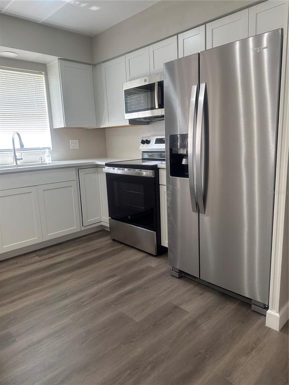 5400 Fox Briar Trail Orlando, FL 32808 - Photo 6 of 31 a kitchen with stainless steel appliances granite countertop a refrigerator sink and microwave
