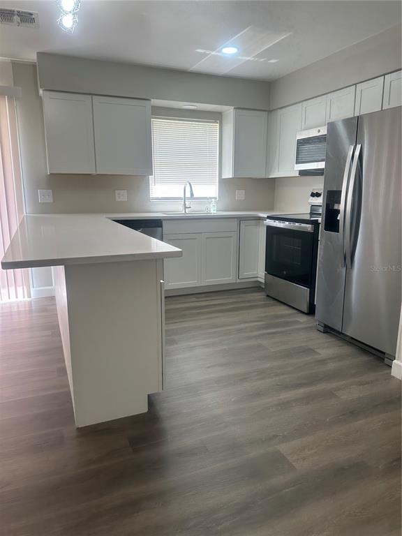 5400 Fox Briar Trail Orlando, FL 32808 - Photo 8 of 31 a kitchen with granite countertop a refrigerator and a sink